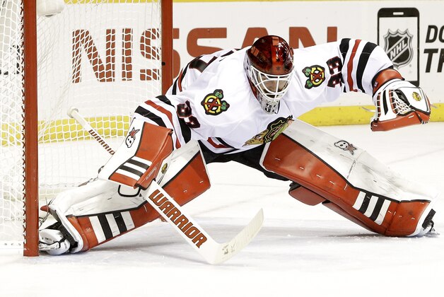 Chicago Blackhawks goalie Scott Darling reaches for the puck in the third period of Game 1 of an NHL Western Conference hockey playoff series against the Nashville Predators Wednesday, April 15, 2015, in Nashville, Tenn. (AP Photo/Mark Humphrey)
