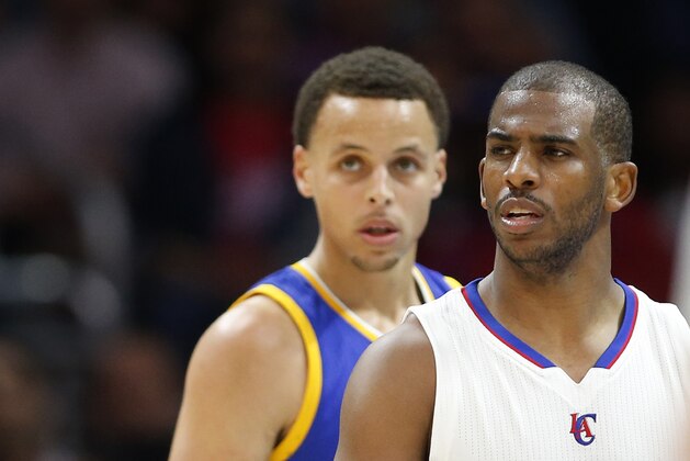 Los Angeles Clippers' Chris Paul, right, and Golden State Warriors' Stephen Curry, left, stand on the court during the second half of an NBA basketball game, Tuesday, March 31, 2015, in Los Angeles. The Warriors won 110-106. (AP Photo/Danny Moloshok)