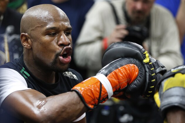 Boxer Floyd Mayweather Jr., left, works out with his uncle Roger Mayweather Tuesday, April 14, 2015, in Las Vegas. Mayweather will face Manny Pacquiao in a welterweight boxing match in Las Vegas on May 2. (AP Photo/John Locher)