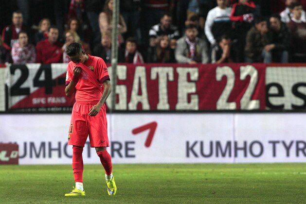 Barcelona's Neymar da Silva from Brazil wipes his face during the La Liga soccer match against Sevilla at the Ramon Sanchez Pizjuan stadium, in Seville, Spain on Saturday, April 11, 2015. (AP Photo/Angel Fernandez)