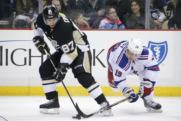 Pittsburgh Penguins' Sidney Crosby (87) battles New York Rangers' Jesper Fast (19) for the puck during the second period of an NHL hockey game in Pittsburgh, Sunday, Jan. 18, 2015. The Rangers won 5-2. (AP Photo/Gene J. Puskar)