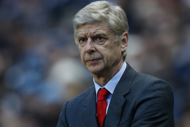Arsenal's head coach Arsene Wenger watches his team play during the English Premier League soccer match between Manchester City and Arsenal at the Etihad Stadium, Manchester, England, Sunday Jan. 18, 2015. (AP Photo/Jon Super)