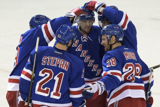 New York Rangers' Rick Nash, center, celebrates his empty-net goal with Kevin Klein, left, Derek Stepan (21) Dominic Moore (28) and Marc Staal, back right, during the third period of an NHL hockey game against the Nashville Predators on Monday, March. 2, 2015, at Madison Square Garden in New York. The Rangers won 4-1. (AP Photo/Bill Kostroun)
