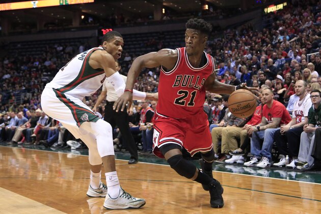 Chicago Bulls guard Jimmy Butler, right, drives to the basket against Milwaukee Bucks forward Giannis Antetokounmpo during the first half of an NBA basketball game Wednesday, April 1, 2015, in Milwaukee. (AP Photo/Darren Hauck)