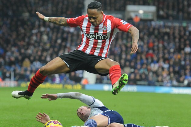 Southampton's Nathaniel Clyne battles for the ball with West Brom's Craig Gardner, bottom, during the English Premier League soccer match between West Bromwich Albion and Southampton at the Hawthorns, West Bromwich, England, Saturday, Feb. 28, 2015. (AP Photo/Rui Vieira)