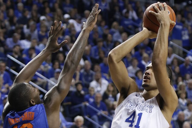 Kentucky's Trey Lyles (41) shoots while pressured by Florida's Dorian Finney-Smith (10) during the first half of an NCAA college basketball game, Saturday, March 7, 2015, in Lexington, Ky. (AP Photo/James Crisp)