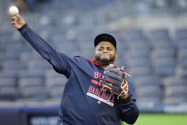 Boston Red Sox third baseman Pablo Sandoval warms up on the tarp before a baseball game against the New York Yankees in New York, Sunday, April 12, 2015. (AP Photo/Kathy Willens)