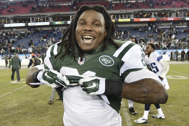 New York Jets running back Chris Johnson removes his jersey after an NFL football game against the Tennessee Titans Sunday, Dec. 14, 2014, in Nashville, Tenn. The Jets won 16-11.(AP Photo/Mark Zaleski)