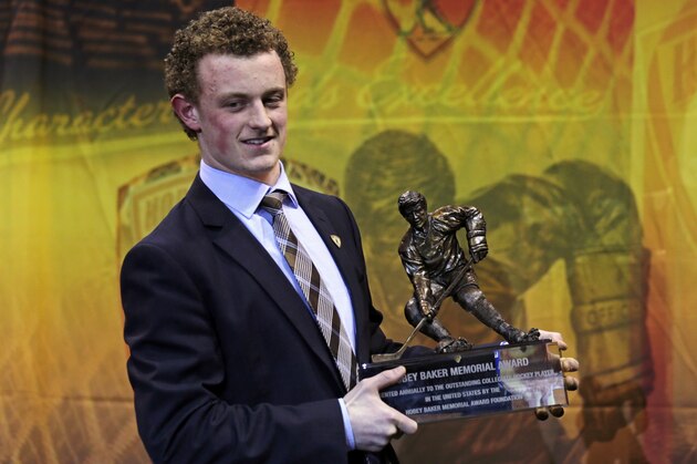 Boston University forward Jack Eichel smiles as he holds his trophy after winning the Hobey Baker Award, recognizing college hockey's top player, in Boston, Friday, April 10, 2015. (AP Photo/Charles Krupa)