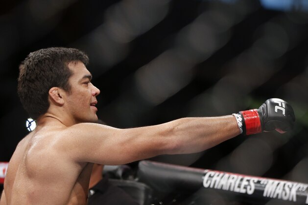 Lyoto Machida, from Brazil, celebrates after defeating CB Dollaway, from the United States, during their UFC middleweight mixed martial arts bout in Barueri, on the outskirts of Sao Paulo, Brazil, early Sunday, Dec. 21, 2014. (AP Photo/Andre Penner)