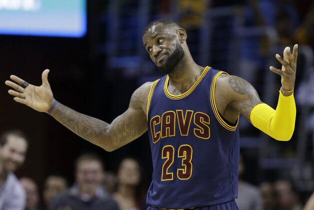 Cleveland Cavaliers' LeBron James reacts after a 3-point shot by Kyrie Irving during the third quarter of an NBA basketball game Sunday, April 5, 2015, in Cleveland. The Cavaliers defeated the Bulls 99-94. (AP Photo/Tony Dejak)