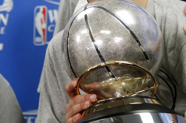 San Antonio Spurs guard Manu Ginobili holds the Western Conference trophy following Game 6 of the NBA basketball playoff series against the Oklahoma City Thunder in Oklahoma City, Saturday, May 31, 2014. San Antonio won 112-107 and advanced to the NBA Finals. (AP Photo/Sue Ogrocki, Pool)