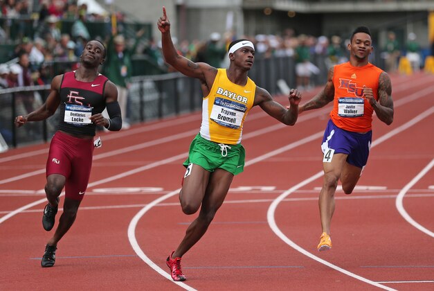 FILE - In this June 13, 2014, file photo, Baylor's Trayvon Bromell, center, celebrates after winning the men's 100 meters while Florida State's Dentarius Locke, left, and Northwestern State's Justin Walker, right, follow at the NCAA track and field championships, in Eugene, Ore. The Baylor freshman set a junior world record in the 100 meters at the NCAA track and field championships last month. He broke the 10-second barrier, running in 9.97 at Hayward Field. Bromell is making bold predictions for the junior world track championships this week. (AP Photo/Rick Bowmer, File)