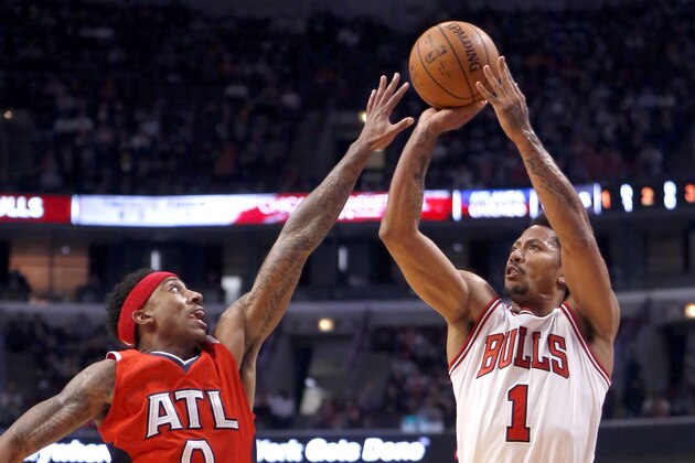 Chicago Bulls guard Derrick Rose (1) shoots over Atlanta Hawks guard Jeff Teague (0) during the first half of an NBA basketball game Wednesday, April 15, 2015, in Chicago. (AP Photo/Charles Rex Arbogast)