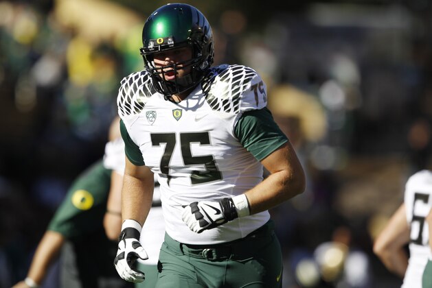 Oregon offensive lineman Jake Fisher warms up before facing Colorado in the first quarter of an NCAA college football game in Boulder, Colo., on Saturday, Oct. 5, 2013. (AP Photo/David Zalubowski)