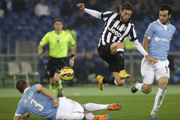 Lazio's Stefan De Vrij, left, and Juventus' Claudio Marchisio vie for the ball during their Serie A soccer match between Lazio and Juventus at Rome's Olympic Stadium, Saturday, Nov. 22, 2014. (AP Photo/Gregorio Borgia)