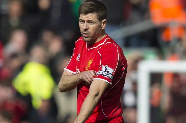 Liverpool's Steven Gerrard removes the captains armband after being sent off by referee Martin Atkinson during the English Premier League soccer match between Liverpool and Manchester United at Anfield Stadium, Liverpool, England, Sunday, March 22, 2015. (AP Photo/Jon Super)