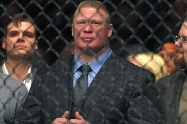 Former UFC heavyweight champion Brock Lesnar watches Ronda Rousey and Cat Zingano as they get ready to fight in a UFC 184 mixed martial arts bantamweight title bout, Saturday, Feb. 28, 2015, in Los Angeles. Rousey won after Zingano tapped out 14 seconds into the first round. (AP Photo/Mark J. Terrill)