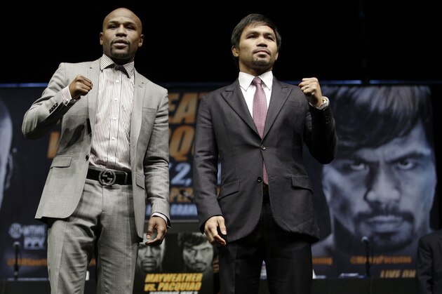 Floyd Mayweather Jr., left, and Manny Pacquiao, of the Philippines, pose for photos after a news conference, Wednesday, March 11, 2015, in Los Angeles. The two are scheduled to fight in Las Vegas on May 2. (AP Photo/Jae C. Hong)