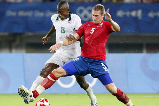 Ivory Coast's Salomon Kalou (8) and Serbia's Slobodan Rajkovic (5) battle for the ball during a men's first round Group A soccer match  at the Beijing 2008 Olympics in Shanghai, Sunday, Aug. 10, 2008. (AP Photo/Eugene Hoshiko)