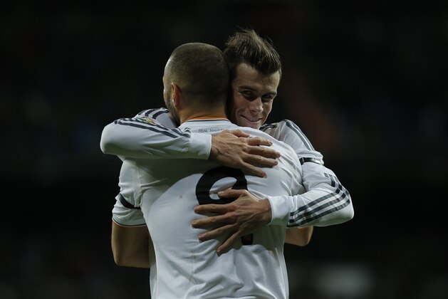 Real Madrid's Karim Benzema from France, left, celebrates his goal with Gareth Bale from Britain during a Spanish La Liga soccer match between Real Madrid and Valladolid at the Santiago Bernabeu stadium in Madrid, Spain, Saturday, Nov. 30, 2013. (AP Photo/Andres Kudacki)