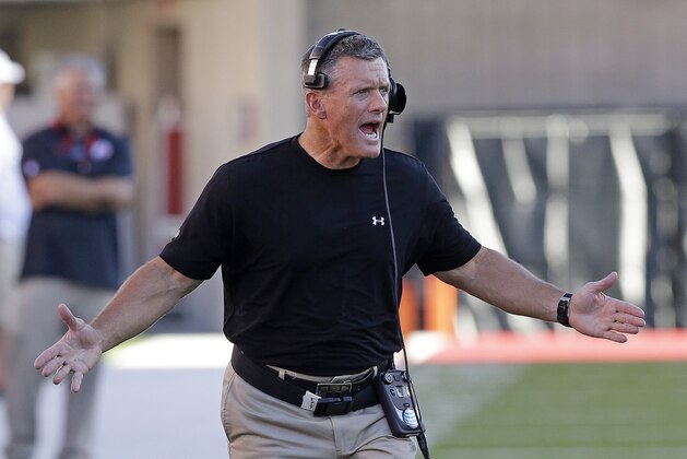 FILE - In this Aug. 28, 2014, file photo, Utah head coach Kyle Whittingham shouts as he runs onto the field in the first quarter during an NCAA football game against Idaho State in Salt Lake City. Utah and Whittingham have agreed to the terms of a new four-year deal that could keep him with the program through 2018. (AP Photo/Rick Bowmer, File)