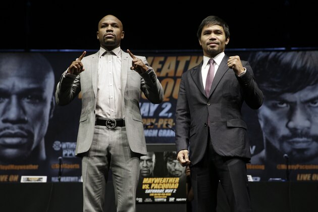 Floyd Mayweather Jr., left, and Manny Pacquiao, of the Philippines, pose for photos after a news conference, Wednesday, March 11, 2015, in Los Angeles. The two are scheduled to fight in Las Vegas on May 2. (AP Photo/Jae C. Hong)