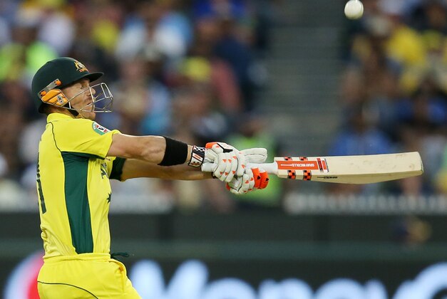 Australia's David Warner hits the ball to the boundary while batting against New Zealand during the Cricket World Cup final in Melbourne, Australia, Sunday, March 29, 2015. (AP Photo/Rick Rycroft)