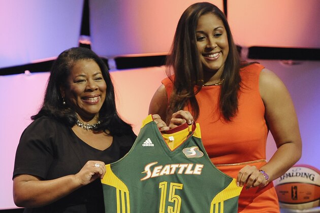 Connecticut's Kaleena Mosqueda-Lewis, right, holds up a Seattle Storm jersey with WNBA president Laurel J. Richie after the Storm selected Mosqueda-Lewis as the No. 3 pick in the WNBA basketball draft, Thursday, April 16, 2015, in Uncasville, Conn. (AP Photo/Jessica Hill)