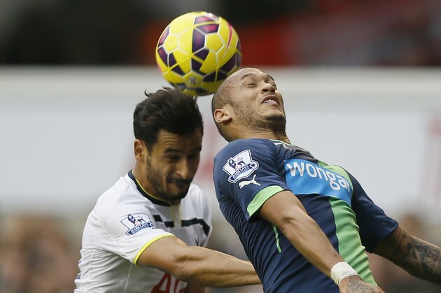 Tottenham's Nacer Chadli, left, competes for the ball with Newcastle's Yoan Gouffran during the English Premier League soccer match between Tottenham Hotspur and Newcastle United at White Hart Lane stadium in London, Sunday, Oct. 26, 2014. (AP Photo/Kirsty Wigglesworth)