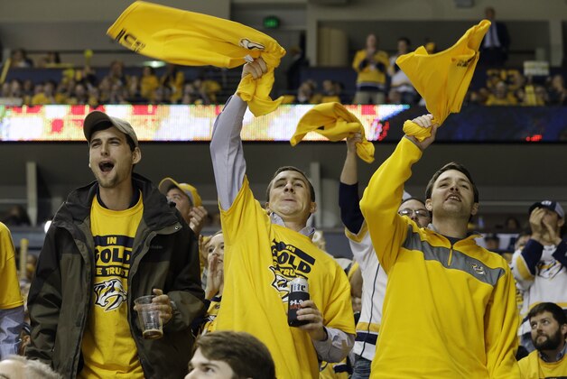 Nashville Predators fans cheer in the third period of Game 1 of an NHL Western Conference hockey playoff series against the Chicago Blackhawks Wednesday, April 15, 2015, in Nashville, Tenn. (AP Photo/Mark Humphrey)