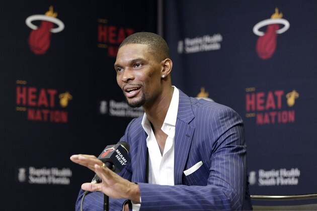 Miami Heat center Chris Bosh gestures as he speaks during a news conference before the start of an NBA basketball game between the Heat and the Boston Celtics, Monday, March 9, 2015, in Miami. Bosh is recovering after falling seriously ill because of blood clots on one of his lungs. The Heat said that Bosh is scheduled to resume