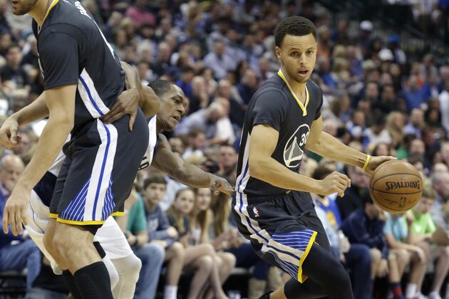Golden State Warriors guard Stephen Curry (30) uses a pick by teammate Andrew Bogut (12) to loose defender Dallas Mavericks guard Rajon Rondo (9) during the first half of an NBA basketball game Saturday, April 4, 2015, in Dallas. (AP Photo/LM Otero)