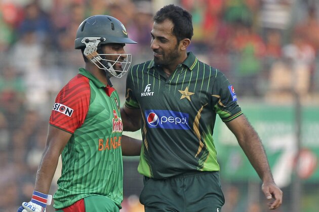 Pakistan’s Wahab Riaz, right, cheers Bangladesh’s Tamim Iqbal, as he walks back to the pavilion after being dismissed during their first one-day international cricket match in Dhaka, Bangladesh, Friday, April 17, 2015. (AP Photo/ A.M. Ahad)