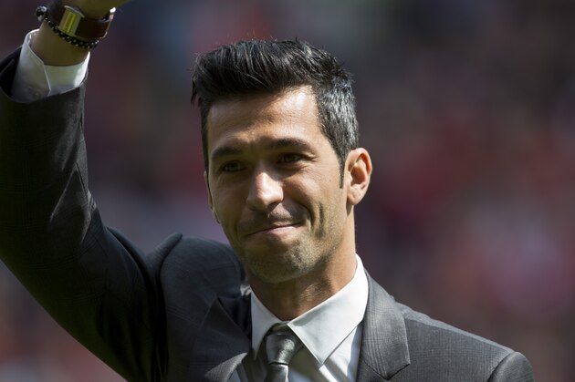 Former Liverpool player Luis Garcia waves to supporters before the team's English Premier League soccer match against Chelsea at Anfield Stadium, Liverpool, England, Sunday April 27, 2014. (AP Photo/Jon Super)