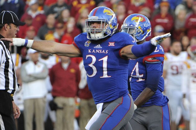 Nov 8, 2014; Lawrence, KS, USA; Kansas Jayhawks linebacker Ben Heeney (31) celebrates a missed field goal by the Iowa State Cyclones in the second half at Memorial Stadium. Kansas won the game 34-14. Mandatory Credit: John Rieger-USA TODAY Sports