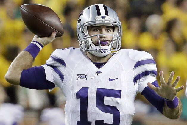 Kansas State quarterback Jake Waters (15) throws under pressure from a Baylor rush in the first half of an NCAA college football game, Saturday, Dec. 6, 2014, in Waco, Texas. (AP Photo/Tony Gutierrez)