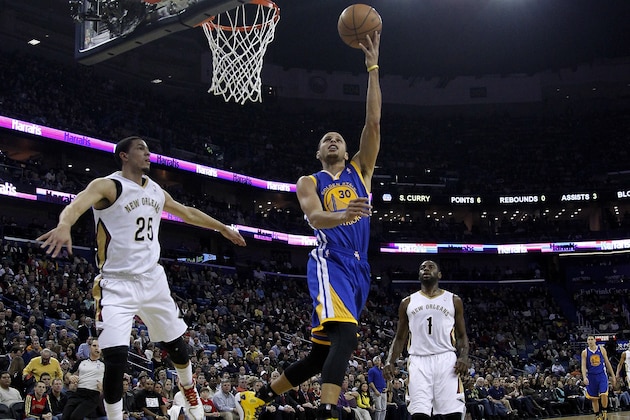 Golden State Warriors point guard Stephen Curry (30) drives past New Orleans Pelicans shooting guard Austin Rivers (25) and point guard Tyreke Evans (1) during the first half of an NBA basketball game in New Orleans, Saturday, Jan. 18, 2014. (AP Photo/Jonathan Bachman)