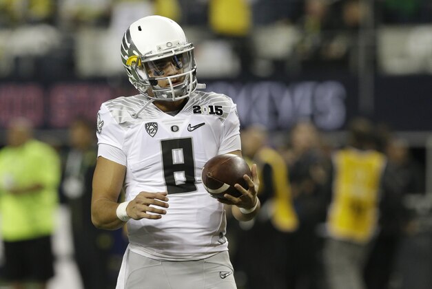 Oregon's Marcus Mariota (8) warms up before the NCAA college football playoff championship game against Oregon Monday, Jan. 12, 2015, in Arlington, Texas. (AP Photo/LM Otero)