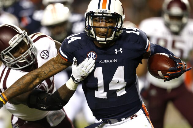 Auburn quarterback Nick Marshall (14) tries to get around Texas A&M Deshazor Everett (29) during the second half of an NCAA college football game on Saturday, Nov. 8, 2014, in Auburn, Ala. (AP Photo/Butch Dill)