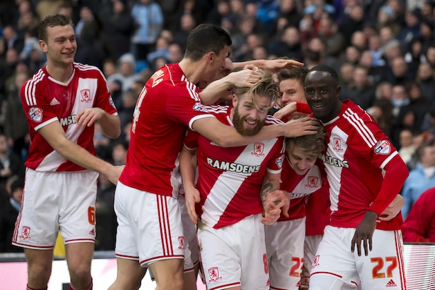 Middlesbrough's Patrick Bamford, lower second right, celebrates with teammates after scoring during the English FA Cup fourth round soccer match between Manchester City and Middlesbrough at the Etihad Stadium, Manchester, England, Saturday, Jan. 24, 2015. (AP Photo/Jon Super)
