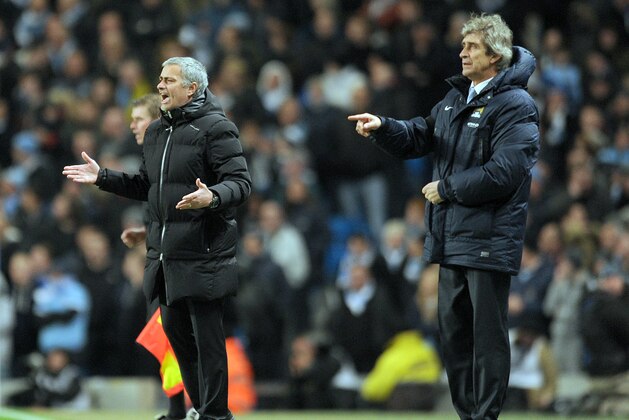 Manchester City's manager Manuel Pellegrini, right, and Chelsea's manager Jose Mourinho during their English Premier League soccer match at the Etihad stadium in Manchester, England, Monday Feb. 3, 2014. (AP Photo/Clint Hughes)