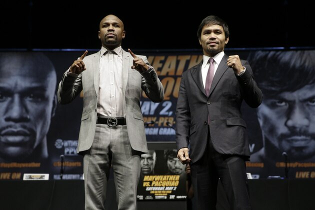 Floyd Mayweather Jr., left, and Manny Pacquiao, of the Philippines, pose for photos after a news conference, Wednesday, March 11, 2015, in Los Angeles. The two are scheduled to fight in Las Vegas on May 2. (AP Photo/Jae C. Hong)