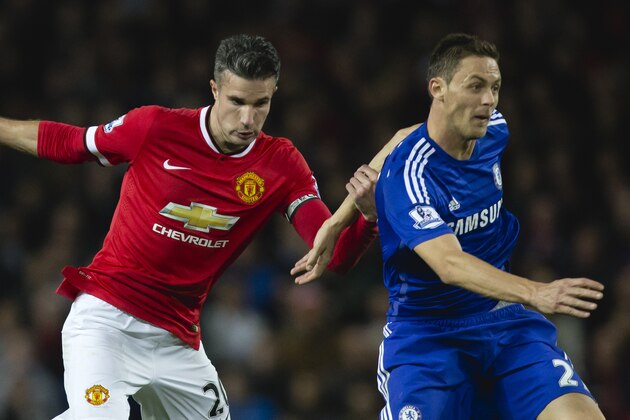 Manchester United's Robin van Persie, left, holds on to Chelsea's Nemanja Matic during the English Premier League soccer match between Manchester United and Chelsea at Old Trafford Stadium, Manchester, England, Sunday Oct. 26, 2014. (AP Photo/Jon Super)