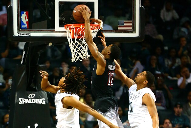 Apr 17, 2015; Brooklyn, NY, USA; East Team guard Charles Matthews (12) goes up for a shot while being defended by theEast Team  in the first half during the Jordan Brand Classic at Barclays Center. The West defeated the East 118-116. Mandatory Credit: Andy Marlin-USA TODAY Sports