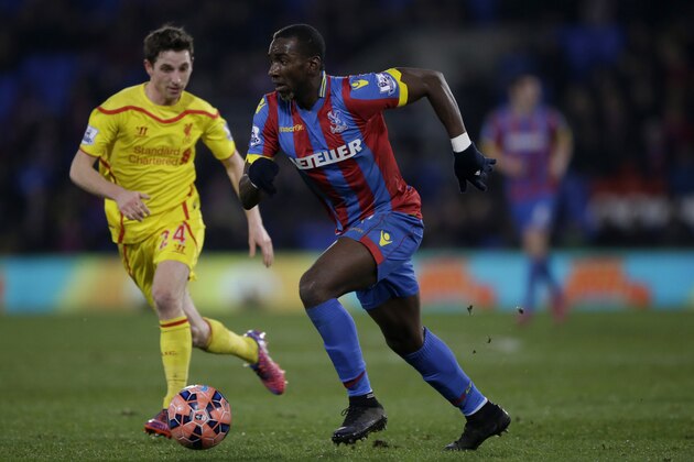 Crystal Palace's Yannick Bolasie, right, competes for the ball with Liverpool's Joe Allen during the English FA Cup fifth round soccer match between Crystal Palace and Liverpool at Selhurst Park stadium in London, Saturday, Feb. 14, 2015.  (AP Photo/Matt Dunham)