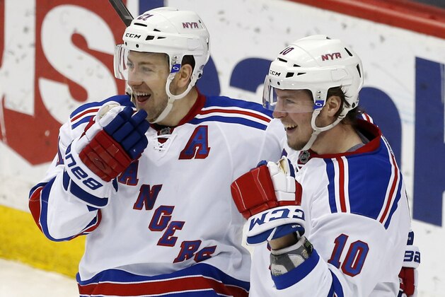 New York Rangers’ Derek Stepan, left, and J.T. Miller celebrate Miller's tie-breaking goal off Minnesota Wild goalie Devan Dubnyk during the third period of an NHL hockey game, Thursday, April 2, 2015, in St. Paul, Minn. The Rangers won 3-2. (AP Photo/Jim Mone)