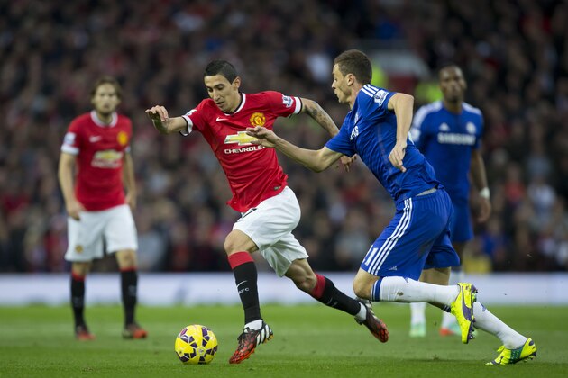 Manchester United's Angel Di Maria, center, fights for the ball against Chelsea's Nemanja Matic during their English Premier League soccer match between Manchester United and Chelsea at Old Trafford Stadium, Manchester, England, Sunday, Oct. 26, 2014. (AP Photo/Jon Super)