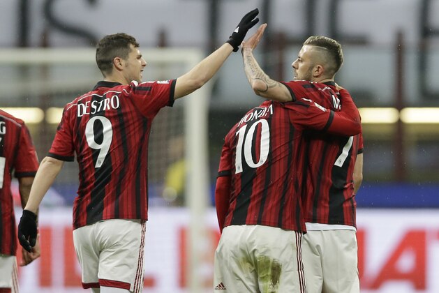 AC Milan's Jeremy Menez, right, celebrates with his teammates AC Milan’s Mattia Destro, left, and AC Milan's Keisuke Honda after scoring during the Serie A soccer match between AC Milan and Cagliari at the San Siro stadium in Milan, Italy, Saturday, March 21, 2015. (AP Photo/Antonio Calanni)