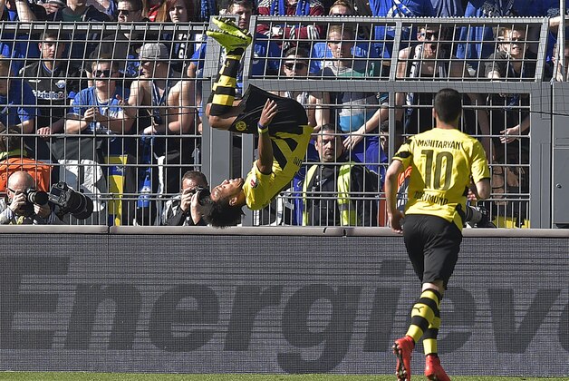 Dortmund's Pierre-Emerick Aubameyang from Gaboon celebrates his goal with a somersault  beside scorer Dortmund's Henrikh Mkhitaryan from Armenia, right, during the German Bundesliga soccer match between Borussia Dortmund and SC Paderborn in Dortmund, Germany, Saturday, April 18, 2015. (AP Photo/Martin Meissner)